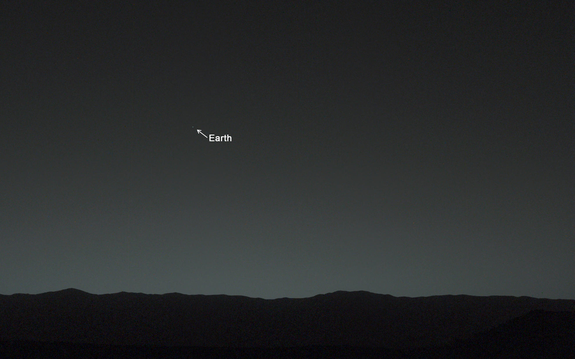 This view of the twilight sky and Martian horizon taken by NASA's Curiosity Mars rover includes Earth as the brightest point of light in the night sky.