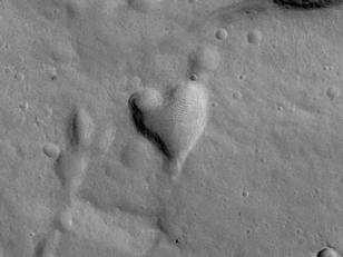 This picture of a heart-shaped pit was taken on 26 February 2008 by the CTX camera aboard MRO. It is approximately 2 km long. The pit is one of many adjacent to Hydaspis Chaos, a jumbled topographic depression thought to have formed by collapse of the surface due to-perhaps-catastrophic release of groundwater.