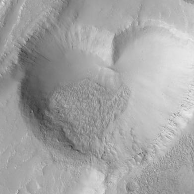 The Mars Global Surveyor (MGS) Mars Orbiter Camera (MOC) took this image in June 1999. This "valentine from Mars" is actually a pit formed by collapse within a straight-walled trough known in geological terms as a graben. Graben are formed along fault lines by expansion of the bedrock terrain.