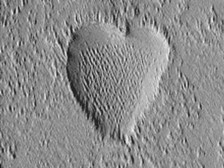 The Mars Global Surveyor (MGS) Mars Orbiter Camera (MOC) took this image in October, 2002.  This richly textured heart is a depression located in the Tharsis region, home to massive, ancient volcanoes on Mars.