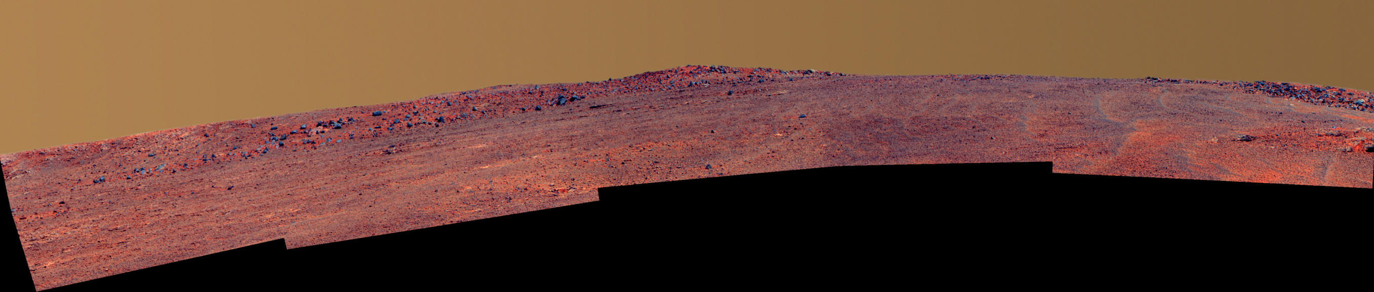 The boulder-studded ridge in this scene recorded by NASA's Mars Exploration Rover Opportunity is "McClure-Beverlin Escarpment," informally named for Jack Beverlin and Bill McClure, engineers who on Feb. 14, 1969, risked their lives to save NASA's second successful Mars mission, Mariner 6, on its launch pad.
