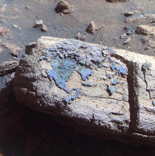 This image from the panoramic camera on NASA's Mars Exploration Rover Opportunity shows a rock called "Chocolate Hills," which the rover found and examined at the edge of a young crater called "Concepción."