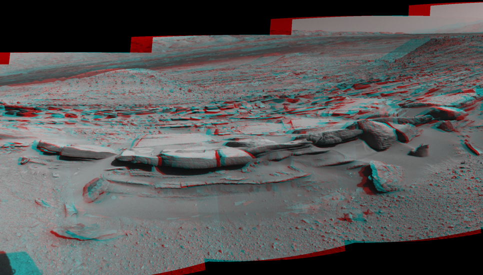 This 160-degree, stereo view from NASA's Curiosity Mars rover is centered southward toward a planned science waypoint at "the Kimberley," with an outcrop of eroded sandstone in the foreground.