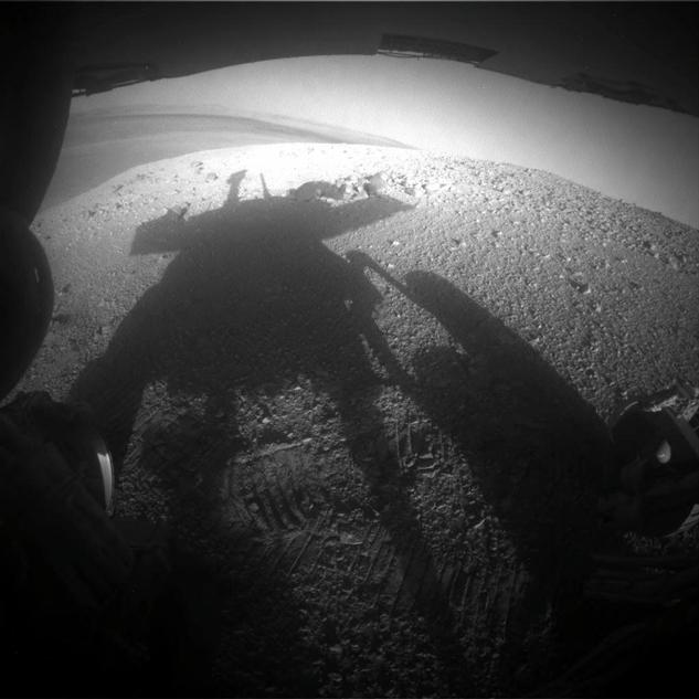 NASA's Mars Exploration Rover Opportunity caught its own silhouette in this late-afternoon image taken by the rover's rear hazard avoidance camera on March 20, 2014.