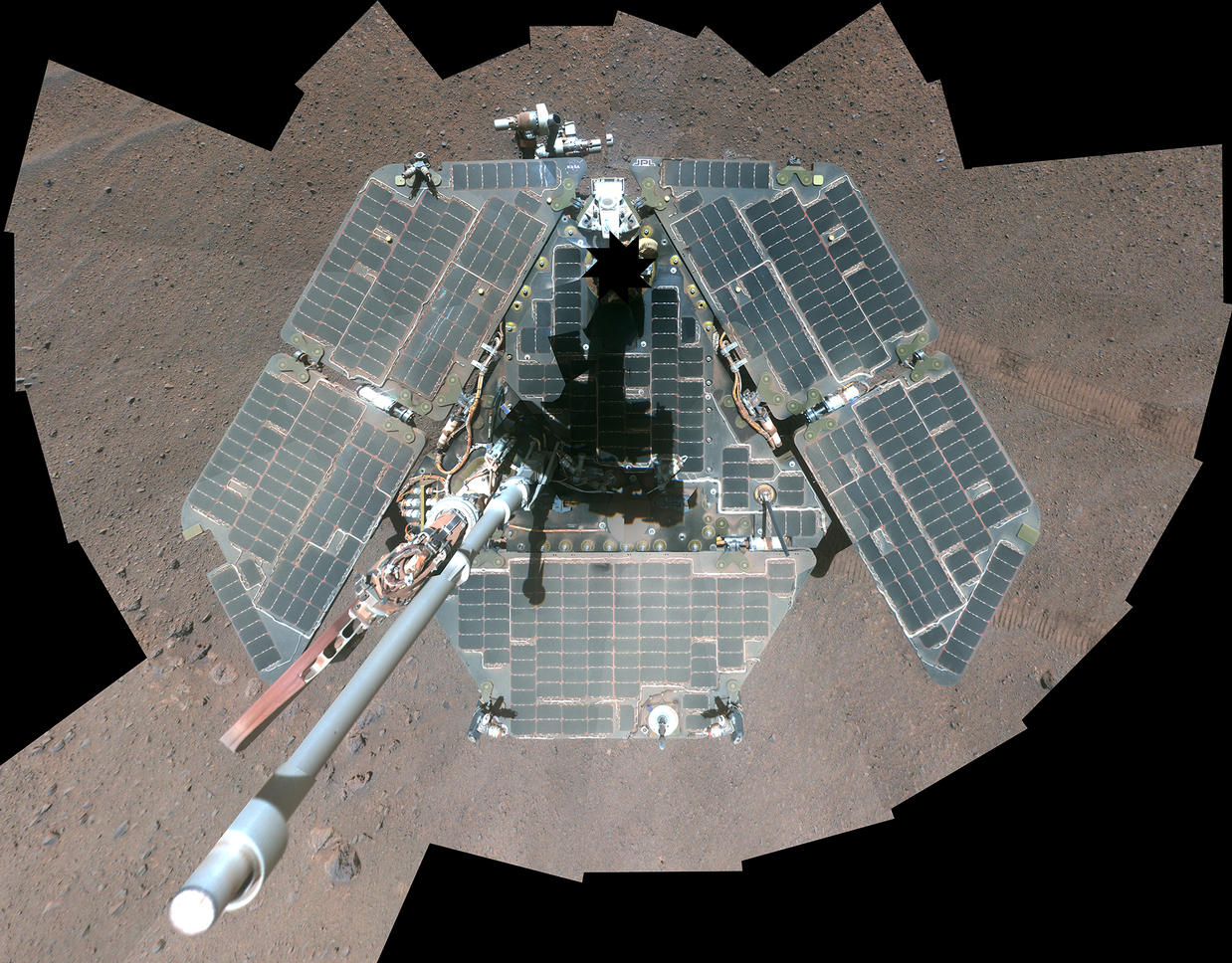 A self-portrait from overhead shows a view of the rover solar panels, which appear grayish-green and wiped clean of dust.
