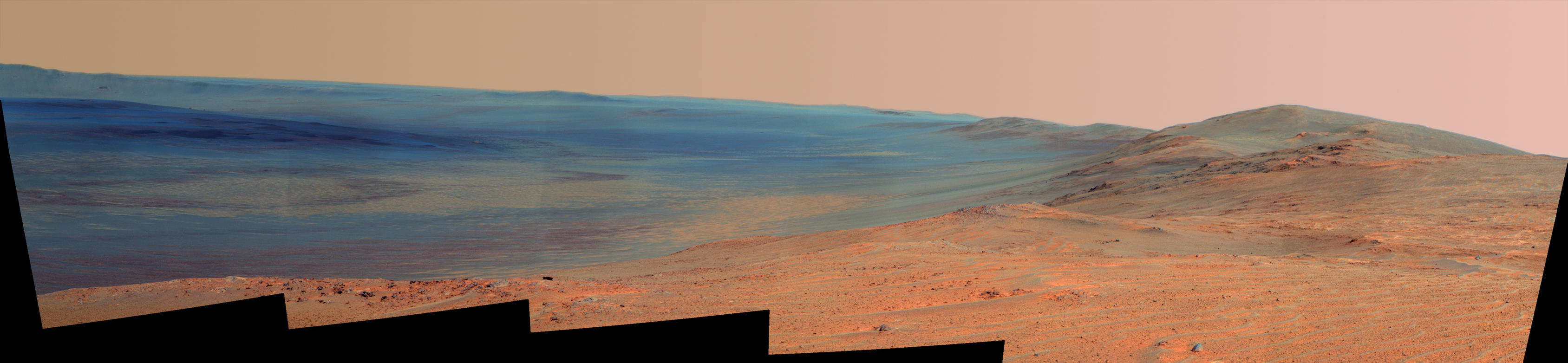 This vista of the Endeavour Crater rim was acquired by NASA's Mars Exploration Rover Opportunity's panoramic camera on April 18, 2014, from "Murray Ridge" on the western rim of the crater. It is presented in false color to make differences in surface materials more easily visible.