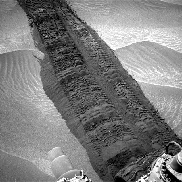 This image from the Navigation Camera on NASA's Curiosity Mars rover shows wheel tracks printed by the rover as it drove on the sandy floor of a lowland called "Hidden Valley" on the route toward Mount Sharp.
