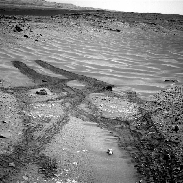 This image from NASA's Curiosity Mars rover looks down the ramp at the northeastern end of "Hidden Valley" and across the sandy-floored valley to lower slopes of Mount Sharp on the horizon.