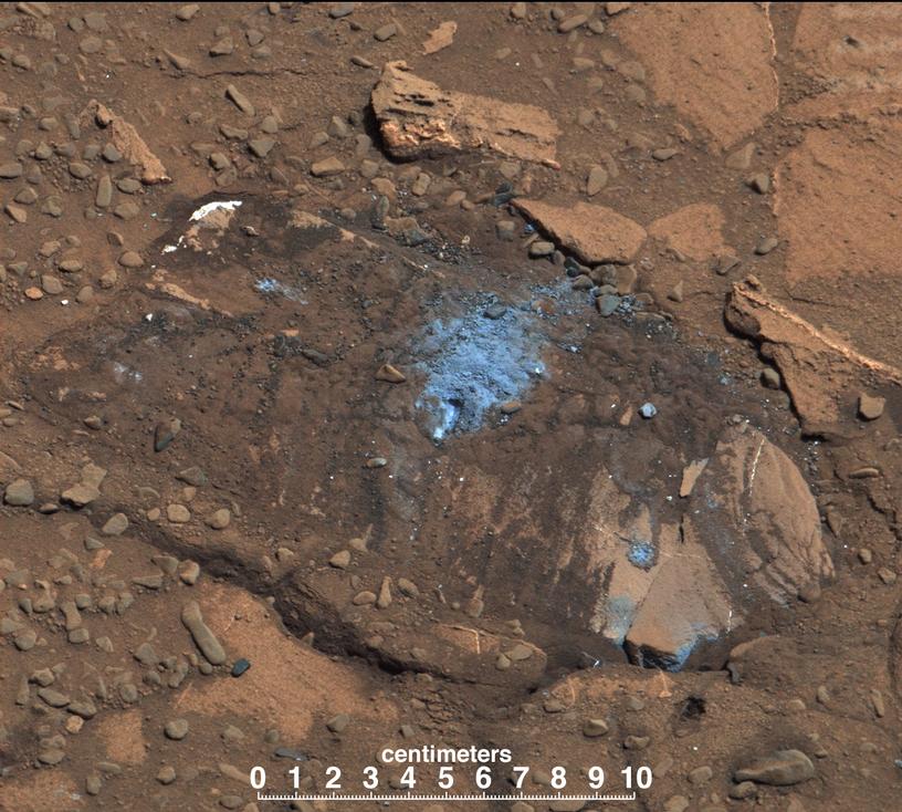 This image of Bonanza King rock, which is brown and has a lighter-blueish area in the middle where the Curiosity tapped the rock.
