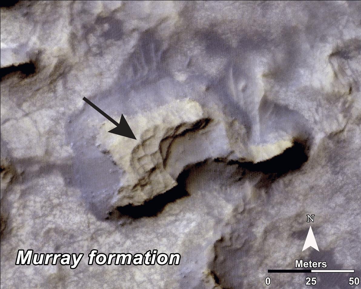 This image shows a mesa (grayish) within the "Murray Buttes" area on Mars showing a complex fracture pattern (black arrow) protruding from the eroding rock.