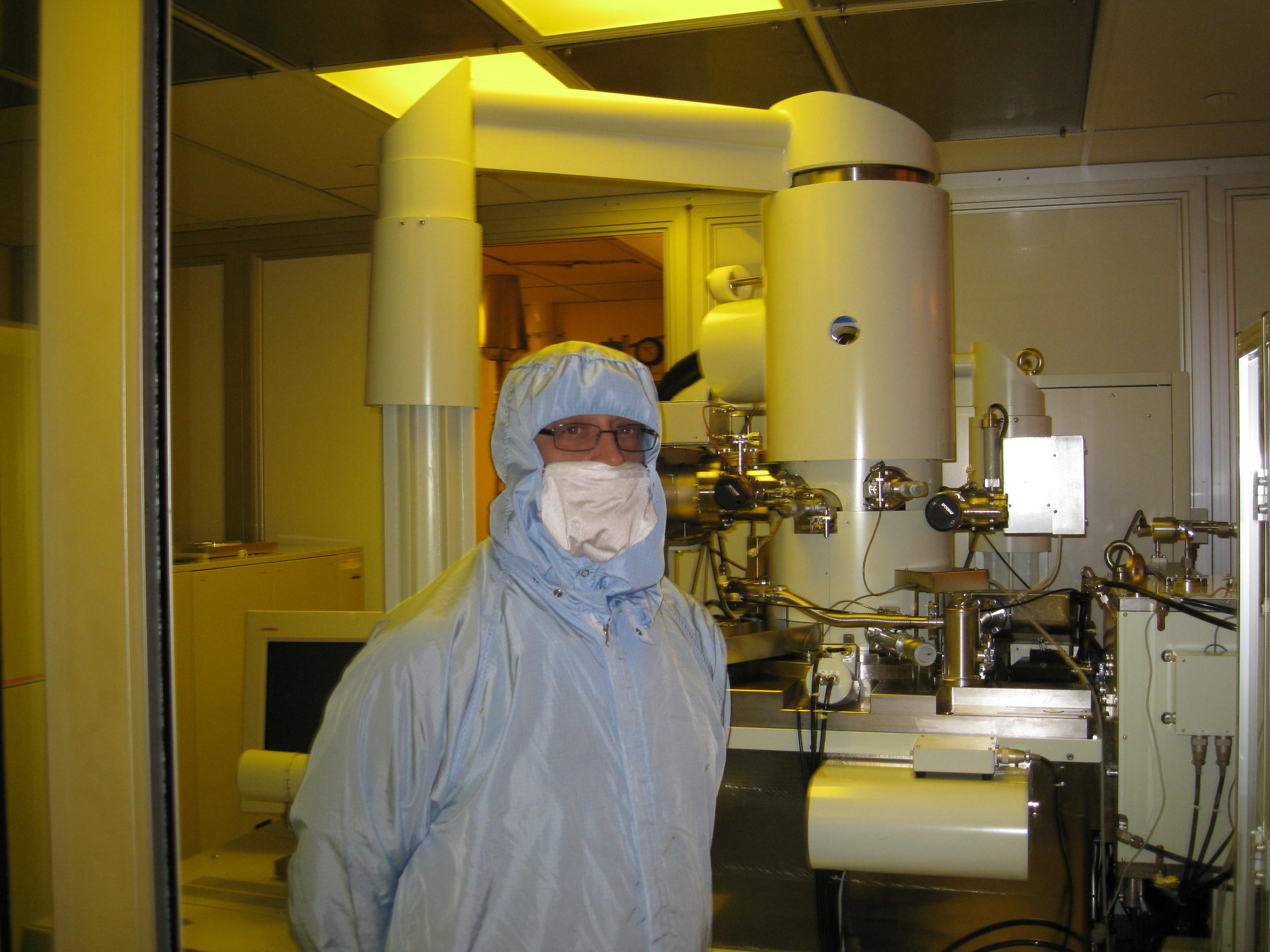 Richard Muller in front of the e-beam lithography tool that wrote over 1.3 million names on the microchip that will fly on Orion.