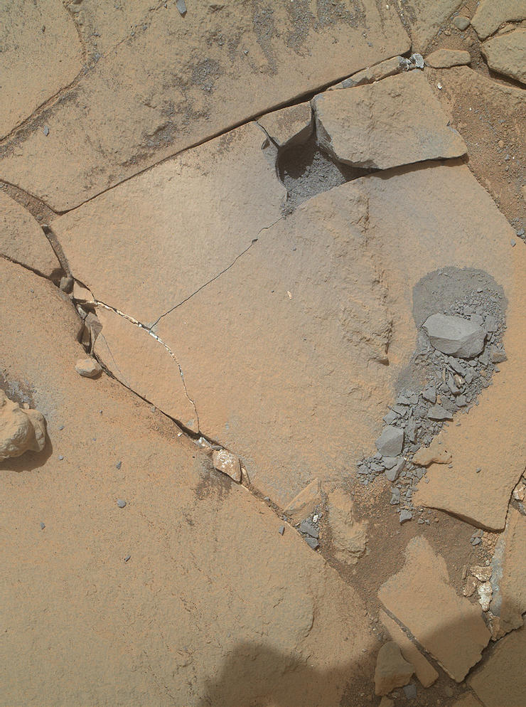This Jan. 13, 2015, view from the Mars Hand Lens Imager on NASA's Curiosity Mars rover shows outcomes of a mini-drill test to assess whether the "Mojave" rock is appropriate for full-depth drilling to collect a sample. Cracking of the rock has made freshly exposed surfaces available for inspection.