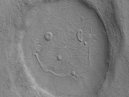 This picture of a crater resembling a "happy face" was taken by the Mars Reconnaissance Orbiter's Context Camera. The unnamed crater is almost 2 miles (about 3 kilometers) across  That's a BIG smile!