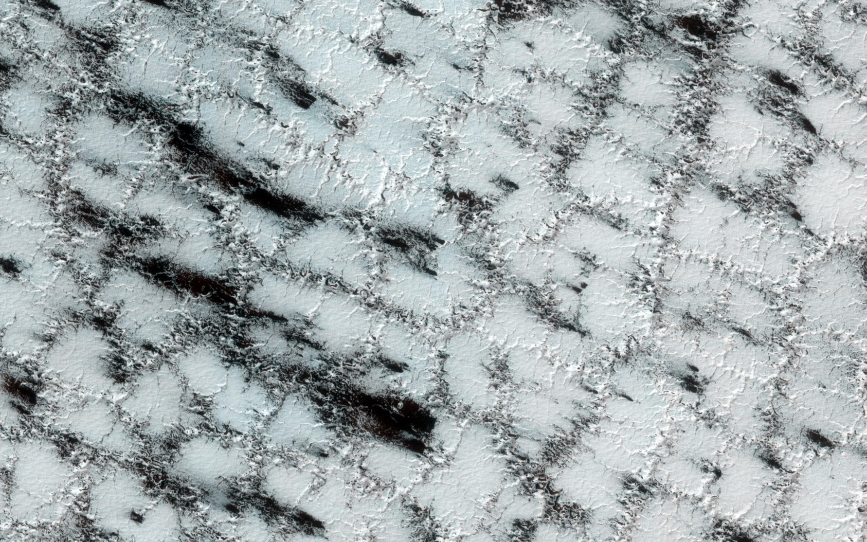 Although the season is late spring, carbon dioxide ice still covers much of the surface at this high latitude site.
