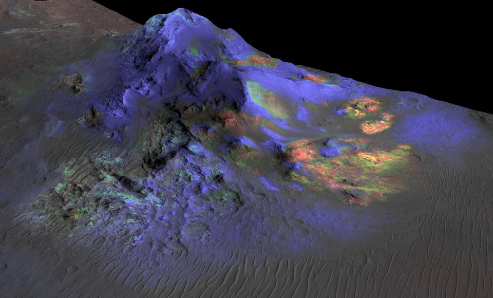 Colorful image showing impact glass distribution on a Martian crater.  These glass deposits are scattered with areas of green showing more glass versus other areas in blue.