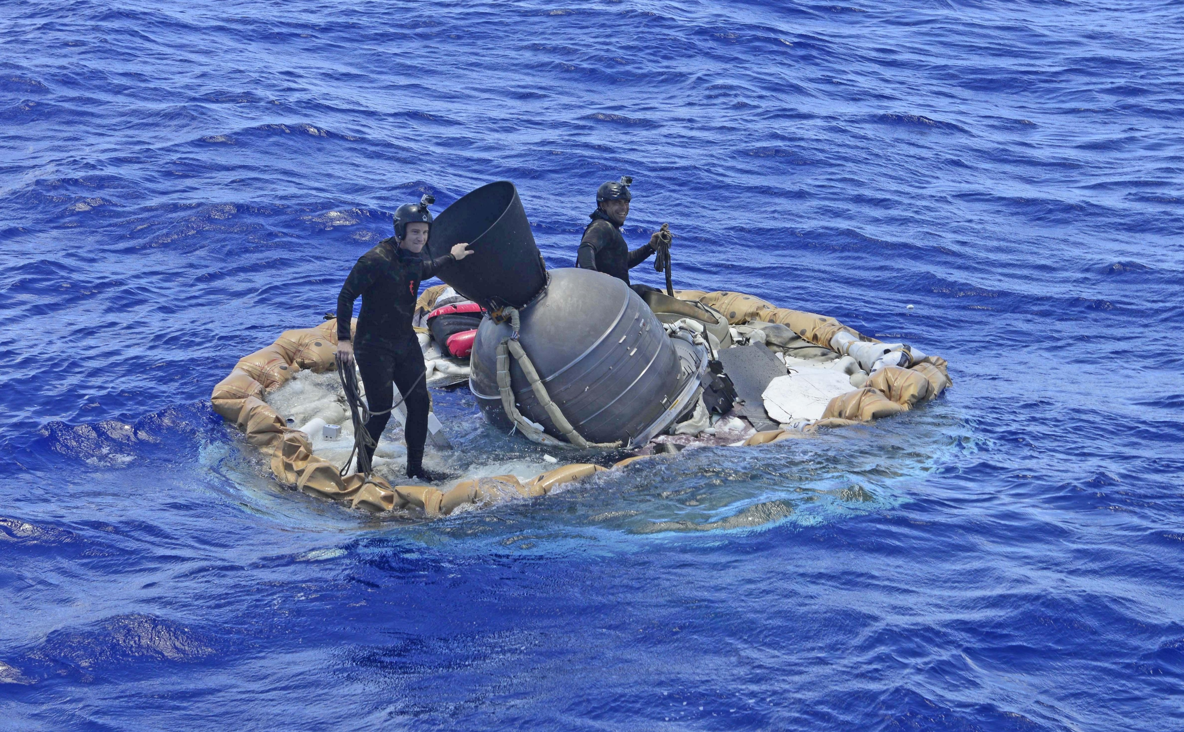 U.S. Navy divers work on recovering the test vehicle for NASA's Low-Density Supersonic Decelerator (LDSD) project.