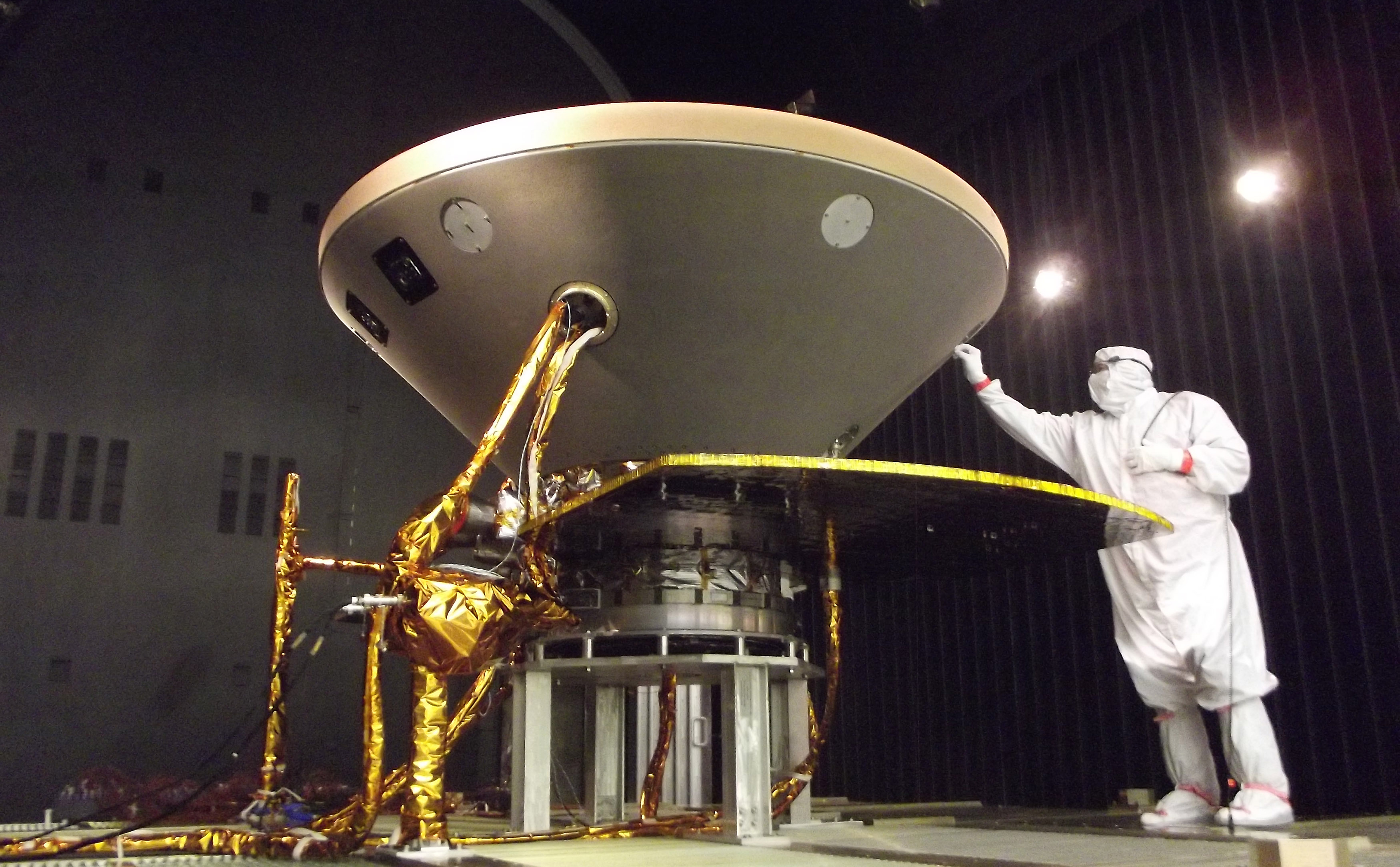 In this photo, a spacecraft specialist prepares NASA's InSight spacecraft for thermal vacuum testing in the flight system's "cruise" configuration for its 2016 flight to Mars.