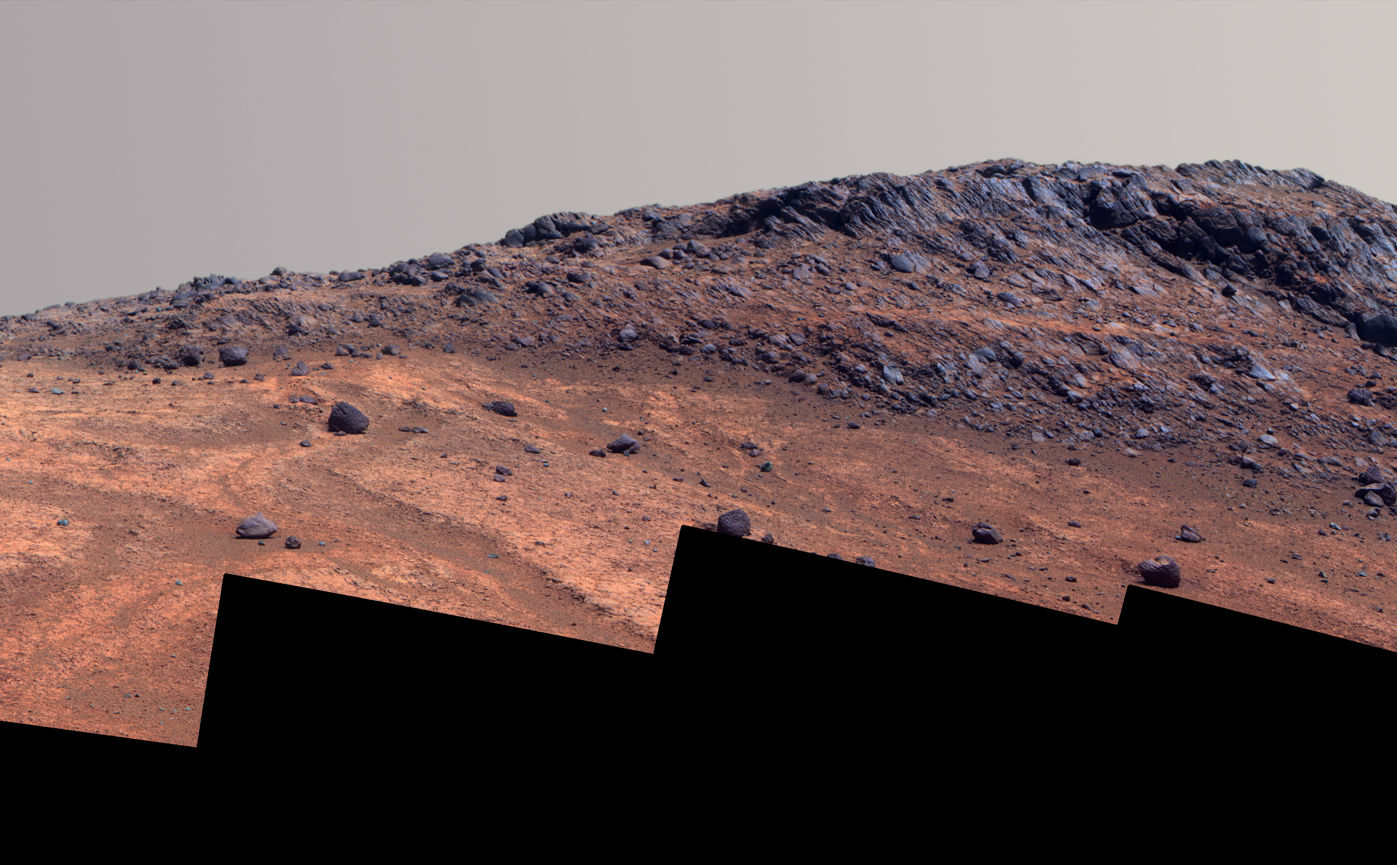 This Martian scene shows contrasting textures and colors of "Hinners Point," at the northern edge of "Marathon Valley," and swirling reddish zones on the valley floor to the left.