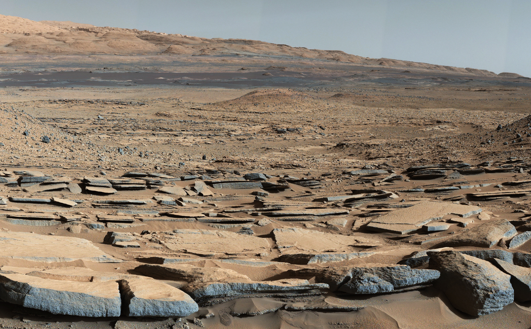 A view from the "Kimberley" formation on Mars taken by NASA's Curiosity rover. The strata in the foreground dip towards the base of Mount Sharp, indicating the ancient depression that existed before the larger bulk of the mountain formed.