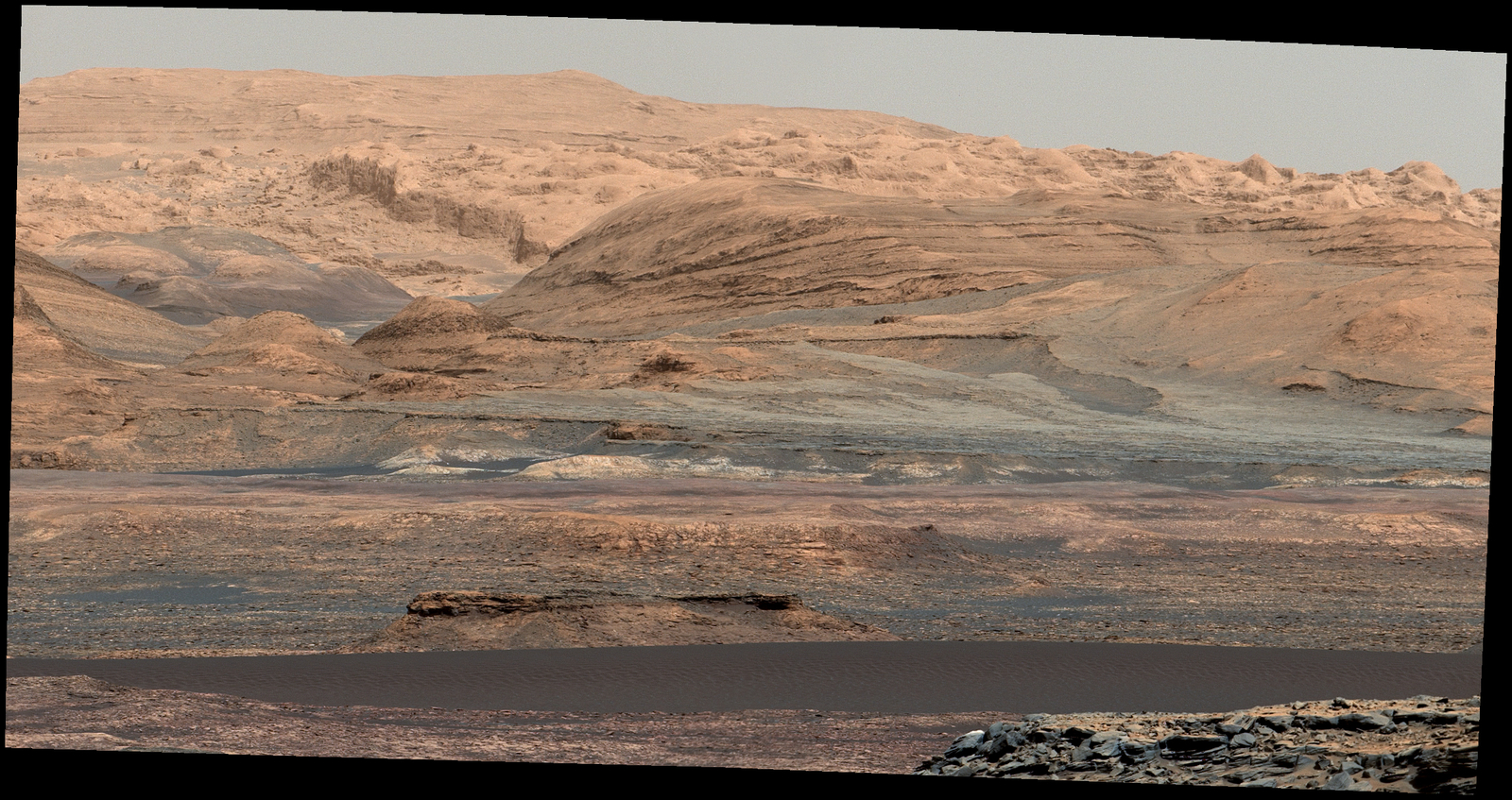 The dark band in the lower portion of this Martian scene is part of the "Bagnold Dunes" dune field lining the northwestern edge of Mount Sharp. The scene combines multiple images taken with the Mast Camera on NASA's Curiosity Mars rover on Sept. 25, 2015. The view is toward south-southeast.