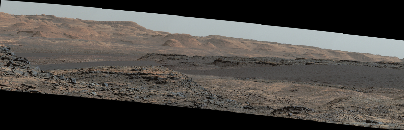 This Sept. 25, 2015, view from the Mast Camera on NASA's Curiosity Mars rover shows a dark sand dune in the middle distance. The rover's examination of dunes on the way toward higher layers of Mount Sharp will be the first in-place study of an active sand dune anywhere other than Earth.