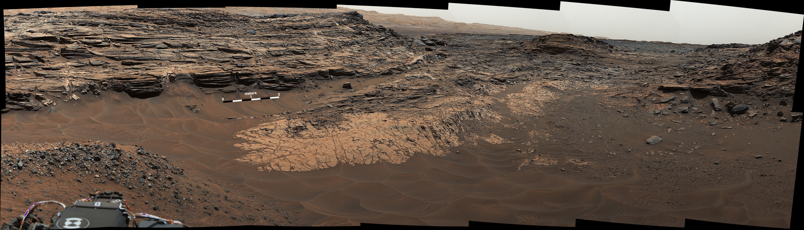 This May 22, 2015, view from the Mast Camera (Mastcam) in NASA's Curiosity Mars rover shows the "Marias Pass" area where a lower and older geological unit of mudstone -- the pale zone in the center of the image -- lies in contact with an overlying geological unit of sandstone.