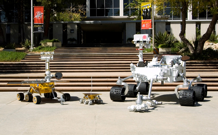Full-scale models of three generations of NASA Mars rovers show the increase in size from the Sojourner rover of the Mars Pathfinder (center), to the twin Mars Exploration Rovers Spirit and Opportunity(left), to the Mars Science Laboratory rover (right).