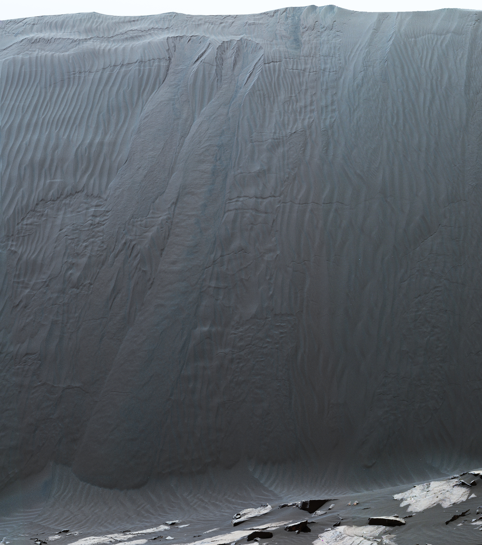 This Dec. 17, 2015, view combines multiple images from the telephoto-lens camera of the Mast Camera (Mastcam) on NASA's Curiosity Mars rover to reveal fine details of the downwind face of "Namib Dune." Sand on this face of the dark dune has cascaded down a slope of about 26 to 28 degrees.