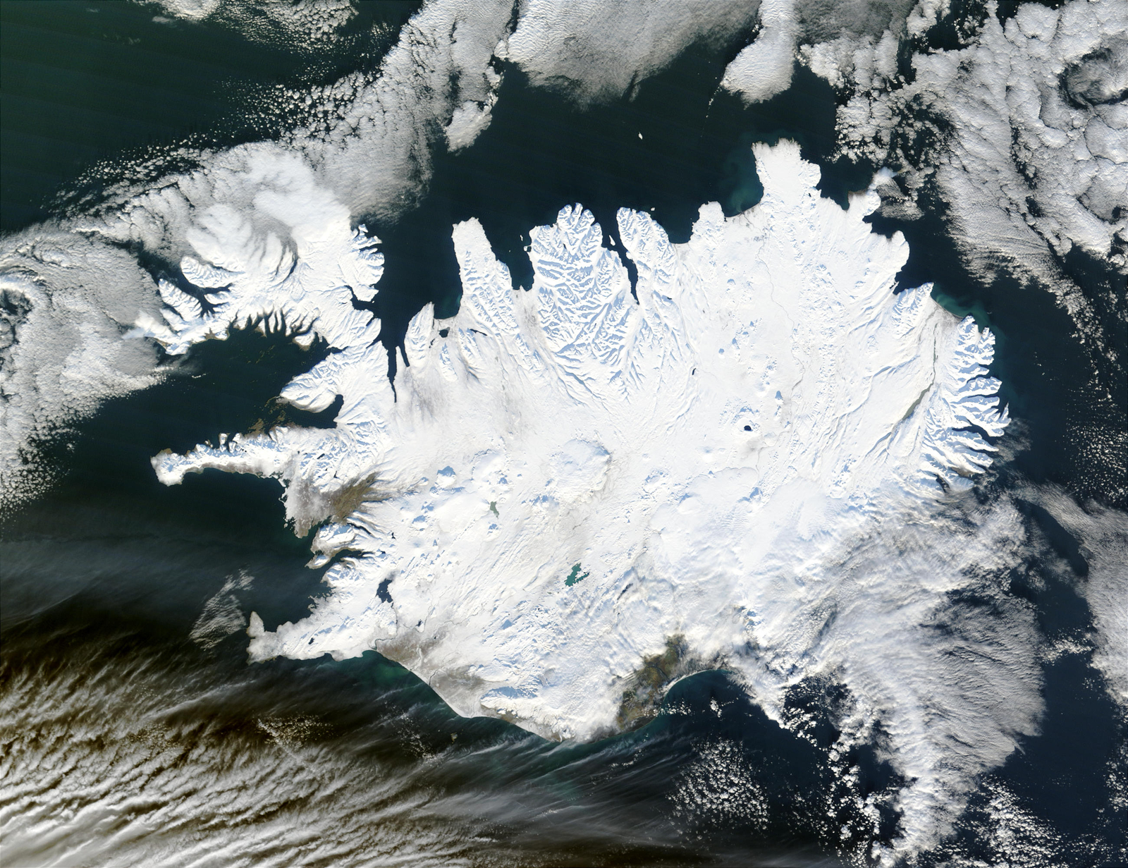A color picture showing snow/ice-capped Iceland with blue ocean surrounding it.