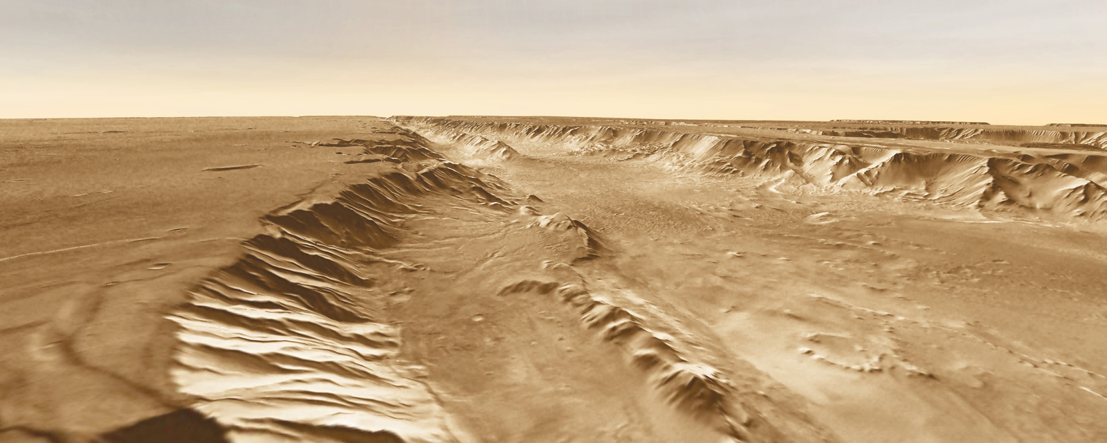 A small basin (center foreground) lies below the southern rim of Melas Chasma, part of Valles Marineris.