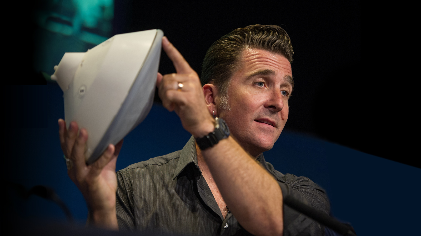 Adam Steltzner of JPL holds up a model of a Mars entry capsule.