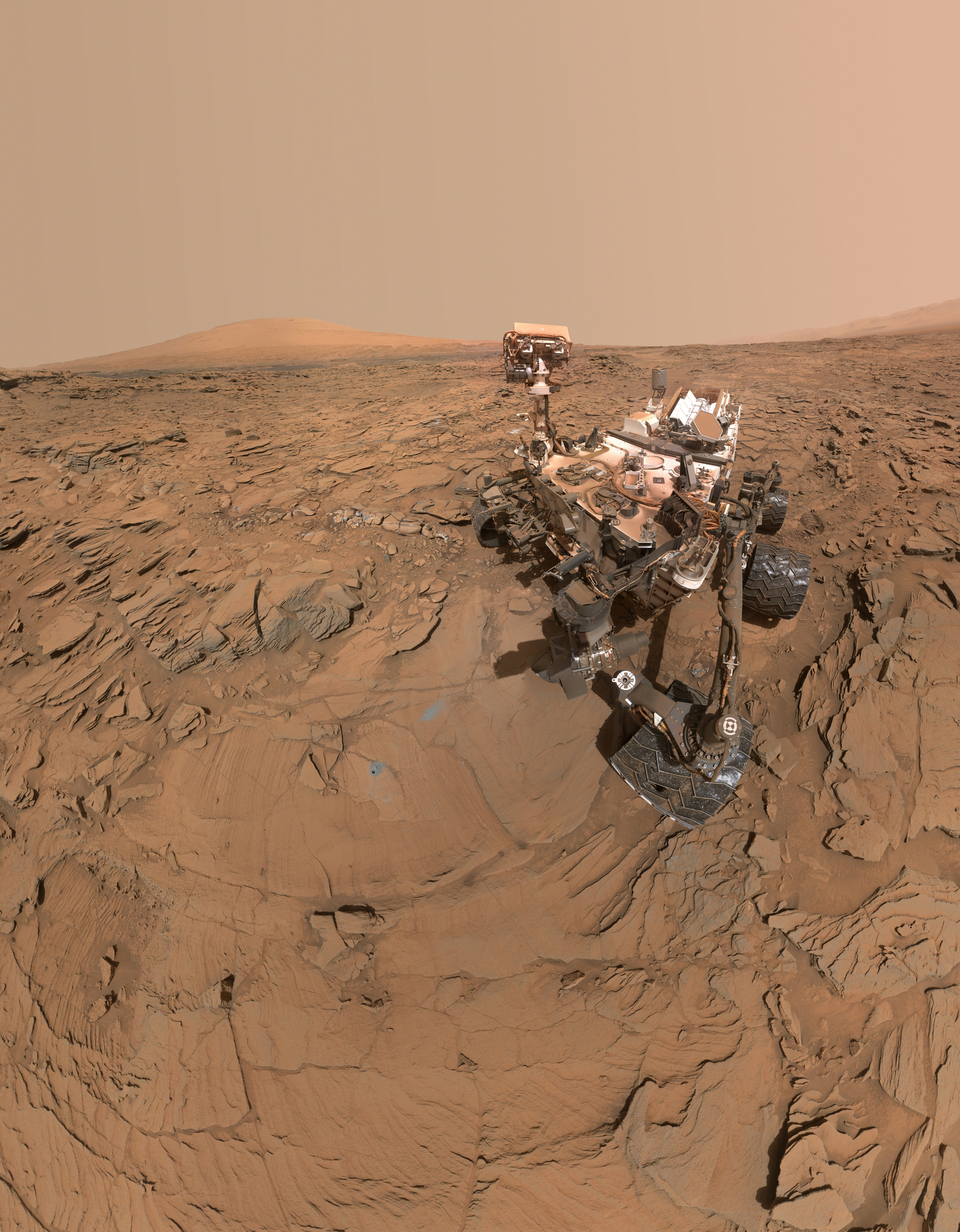 The top of the rover's mast faces away in this May 11, 2016, self-portrait of NASA's Curiosity Mars rover, which shows the vehicle at the "Okoruso" drilling site on lower Mount Sharp. The scene is a mosaic of multiple images taken with the arm-mounted Mars Hands Lens Imager (MAHLI).