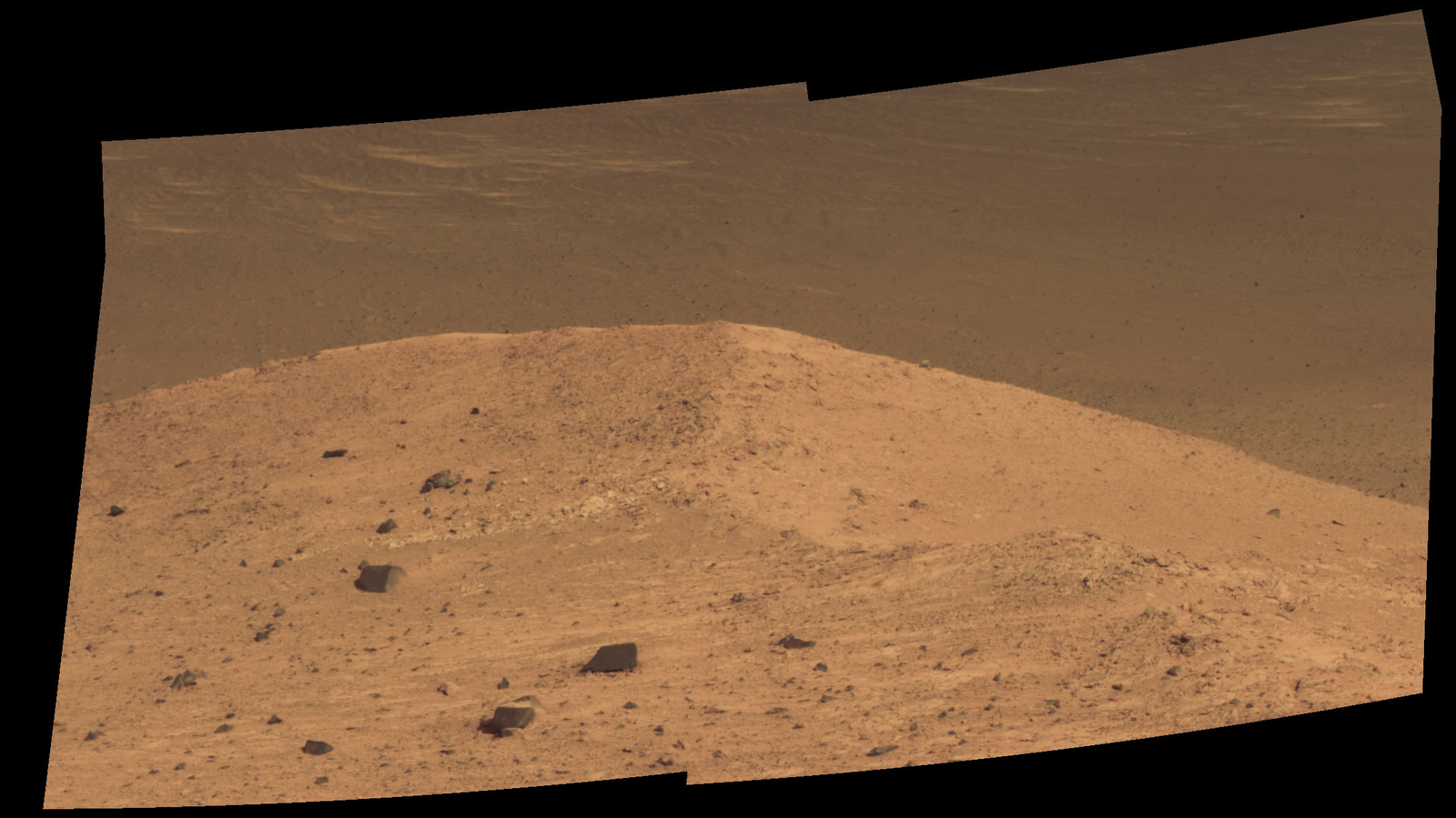 This Sept. 21, 2016, scene from the panoramic camera (Pancam) on NASA's Mars Exploration Rover Opportunity shows "Spirit Mound" overlooking the floor of Endeavour Crater. The mound stands near the eastern end of "Bitterroot Valley" on the western rim of the crater, and this view faces eastward.