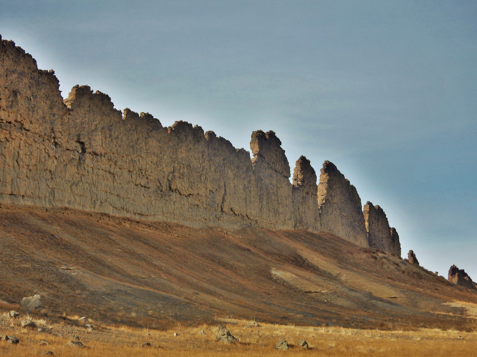 This photograph from Shiprock in northwestern New Mexico shows a ridge roughly 30 feet (about 10 meters) tall that formed from lava filling an underground fracture then resisting erosion better than the material around it did.