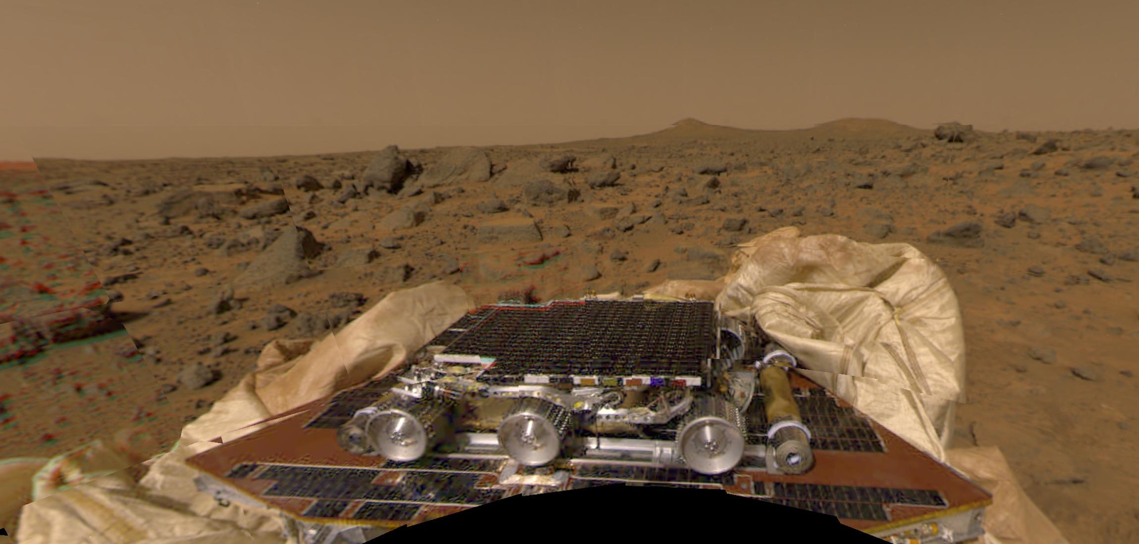 NASA's Sojourner rover and undeployed ramps onboard the Mars Pathfinder spacecraft can be seen in this image, by the Imager for Mars Pathfinder (IMP) on July 4, 1997 (Sol 1).