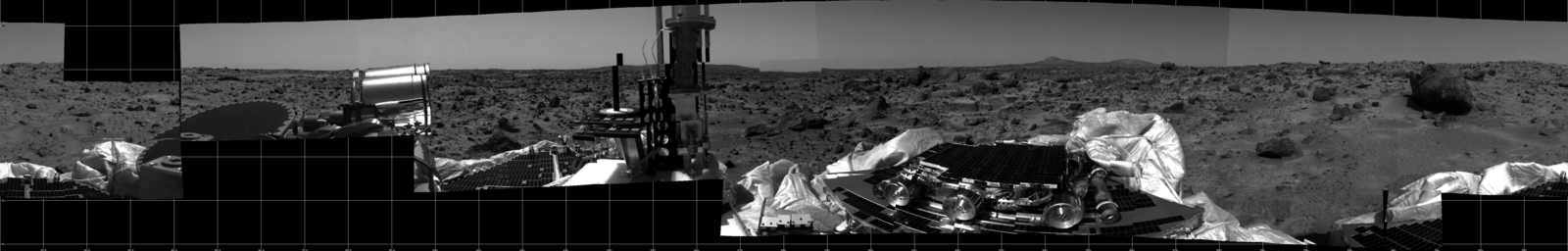 This photomosaic was taken by the Imager for Mars Pathfinder (IMP) camera on July 4, 1997 between 4:00-4:30 p.m. PDT. The foreground is dominated by the lander, newly renamed the Sagan Memorial Station after the late Dr. Carl Sagan.