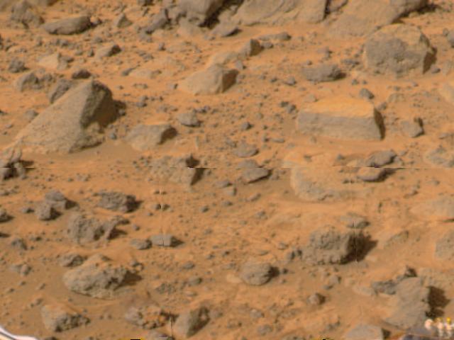Flat Top,' the rectangular rock at right, is part of a stretch of rocky terrain in this image, taken by NASA's deployed Imager for Mars Pathfinder (IMP) on July 7, 1997. The rock dubbed 'Wedge' is at left.