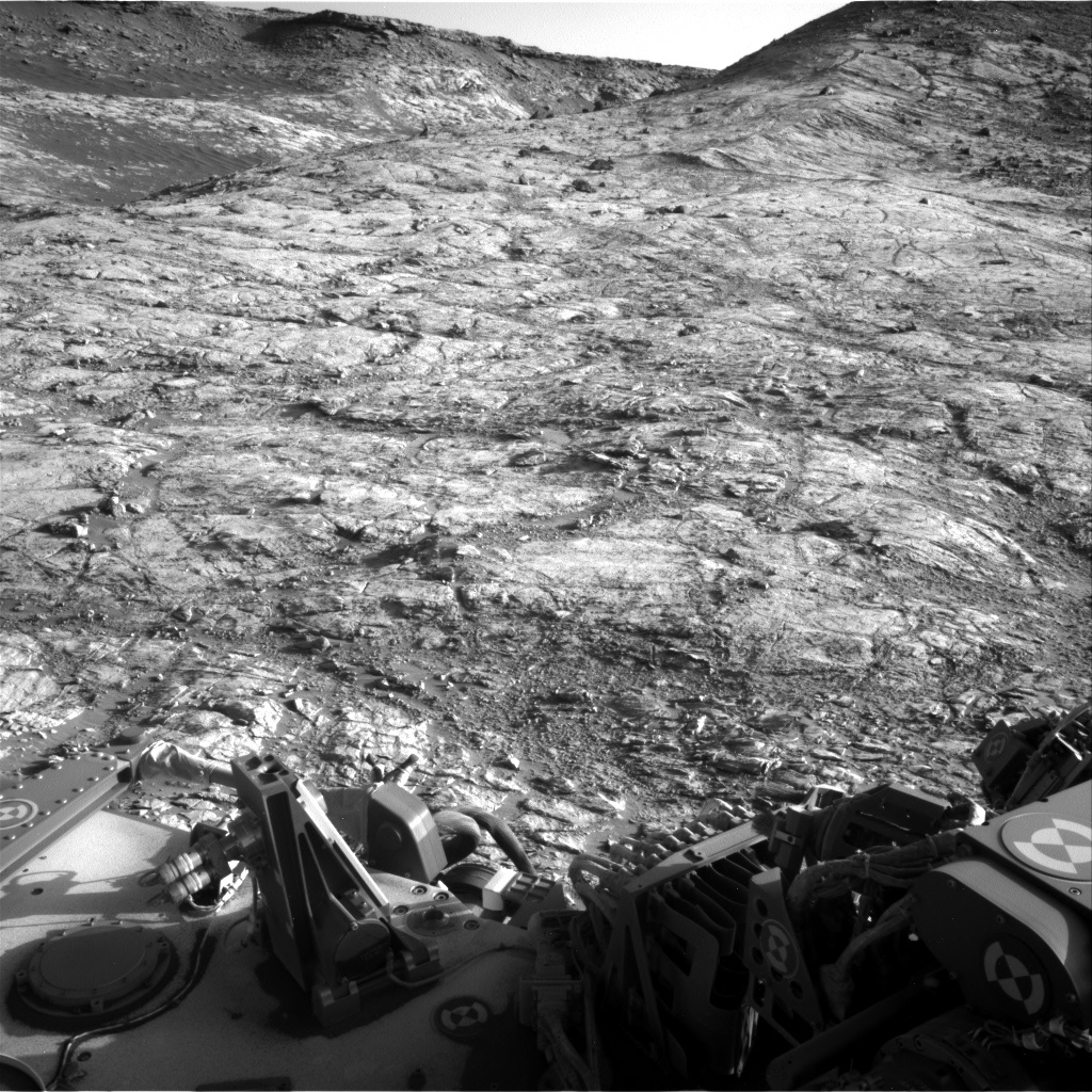 Navcam right image looking south-southeast with light coloured mudstone in the foreground. One of the darker colored, loose blocks that sit on top of the light rock in the top right of the image is our planned end of drive location.