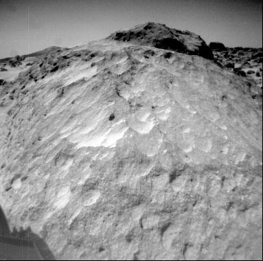 A close-up view of the rock 'Moe' in the Rock Garden at the Pathfinder landing site. Moe is a meter-size boulder that, as seen from NASA's Sojourner, has a relatively smooth yet pitted texture upon close examination. Sol 1 began on July 4, 1997.