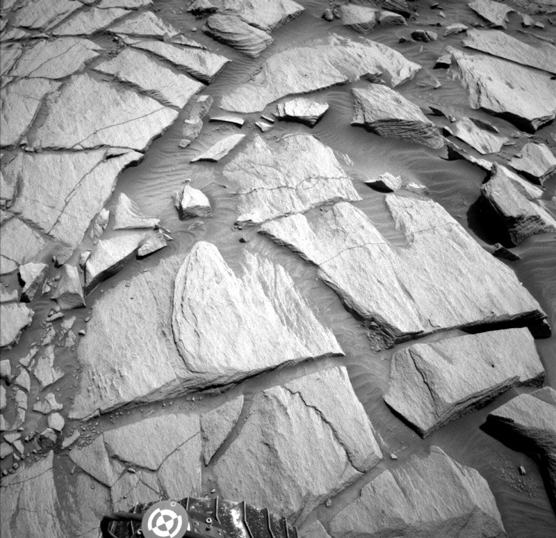 A black and white view of Mars and Curiosity