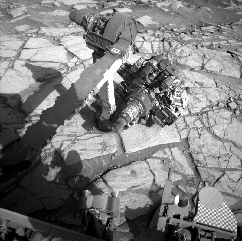 Curiosity’s arm over the drill tailings from the Edinburgh drill hole