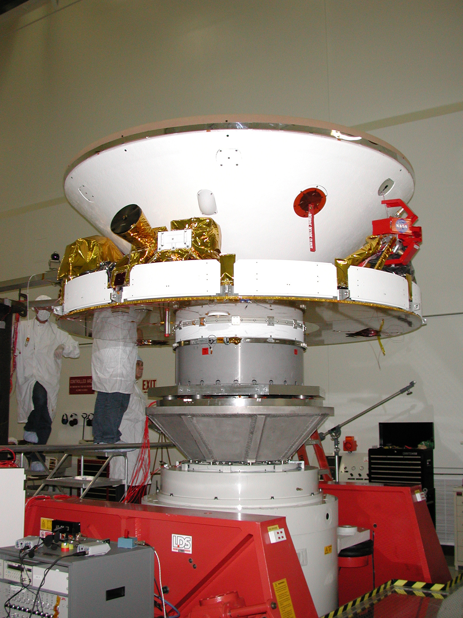 In this photo, engineers are preparing the rover for vibration testing to ensure that it can undergo the rigors of launch and entry into the martian atmosphere. The rovers are scheduled to launch next spring and will arrive at Mars in January 2004.