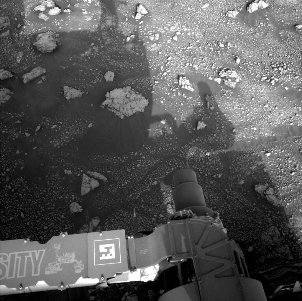 Part of Curiosity rover is visible in this image of Mars