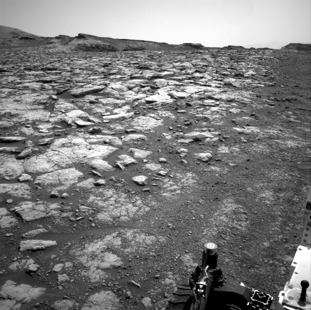 Parts of Curiosity rover are visible in this image of Mars