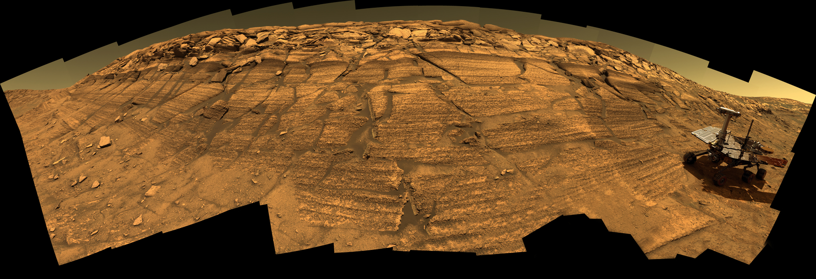 This synthetic image of NASA's Opportunity Mars Exploration Rover inside Endurance Crater was produced using "Virtual Presence in Space" technology.