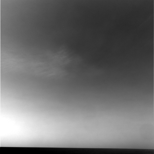 NASA's Mars Exploration Rover Opportunity captured a view of wispy afternoon clouds, not unlike fair weather clouds on Earth, passing overhead on the rover's 956th sol, or Martian day (Oct. 2, 2006).