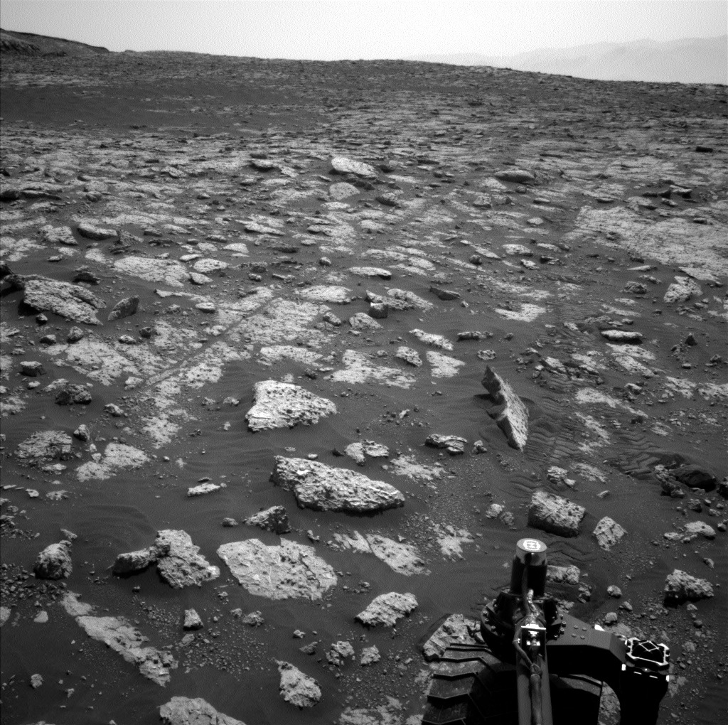Part of Curiosity rover and a view of Mars