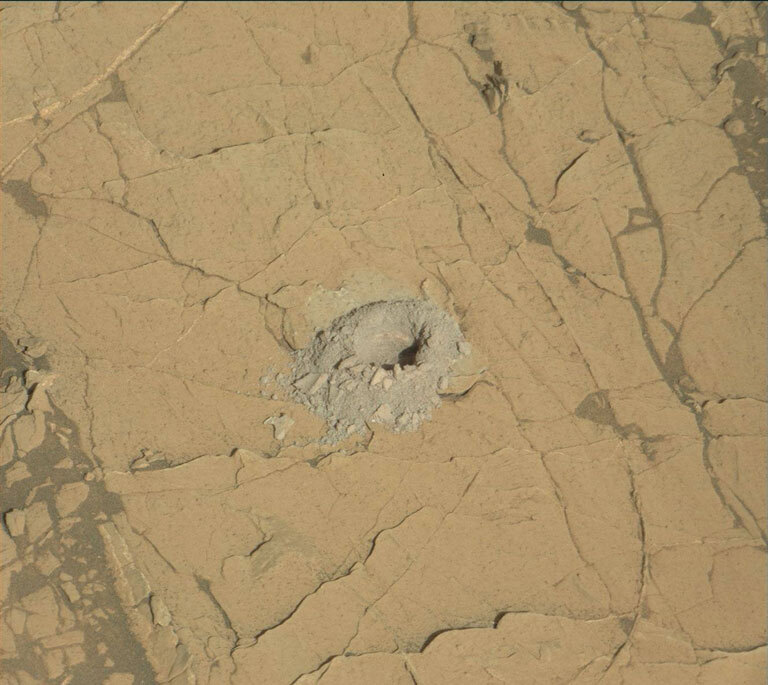 A hole in a Martian rock drilled by Curiosity