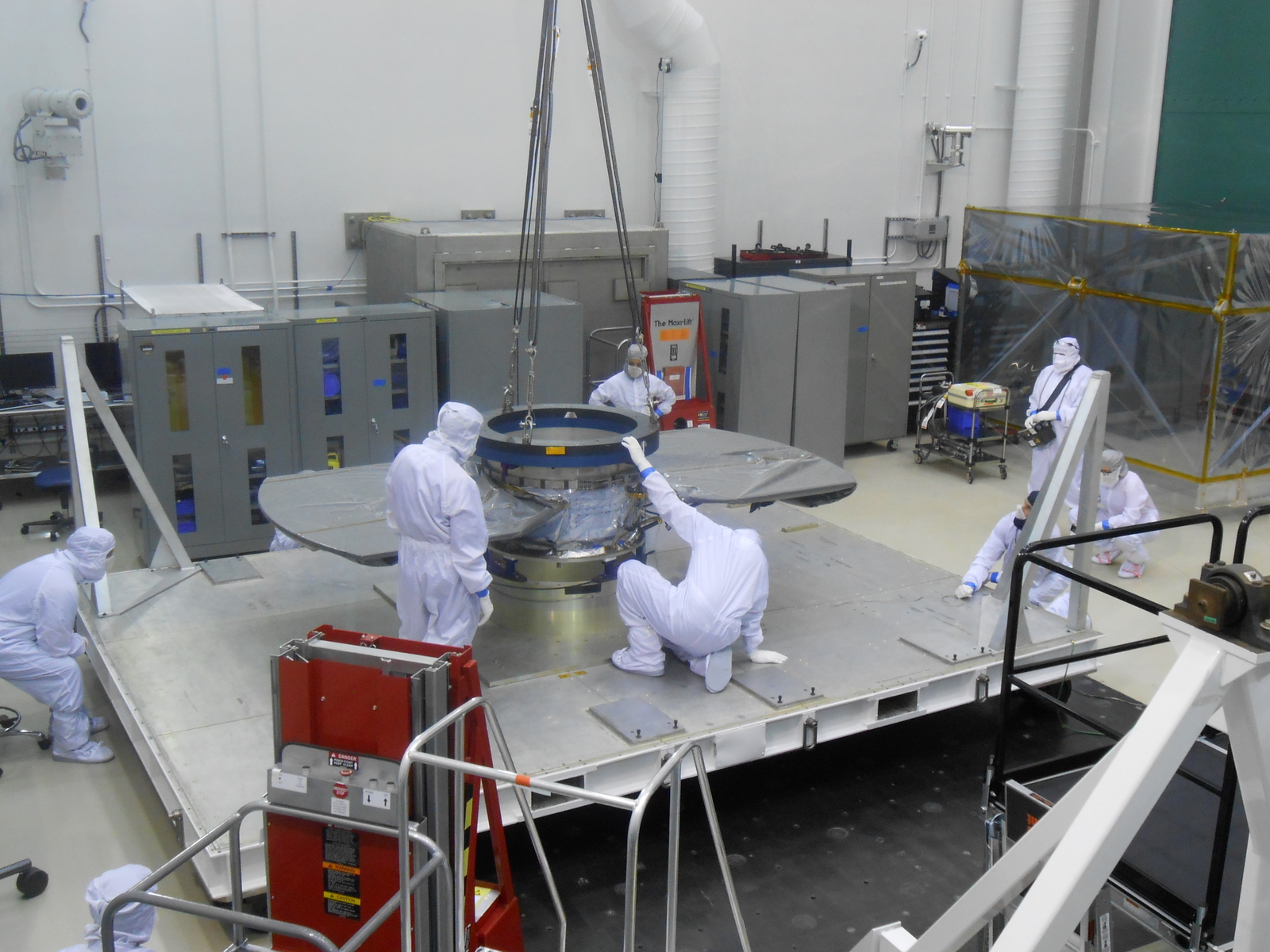 Lockheed Martin spacecraft specialists check the cruise stage of NASA's InSight spacecraft in this June 22, 2017, photo. The cruise stage will provide vital functions during the flight from Earth to Mars, and then will be jettisoned before the rest of the spacecraft enters Mars' atmosphere.