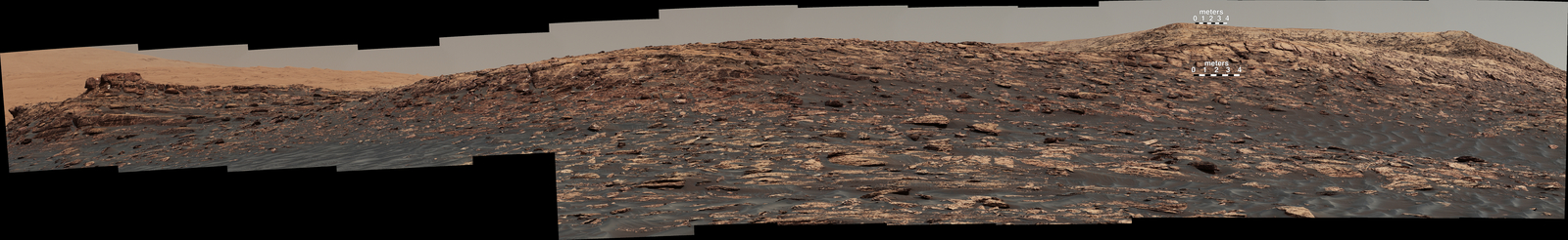 "Vera Rubin Ridge," a favored destination for NASA's Curiosity Mars rover even before the rover landed in 2012, rises near the rover nearly five years later in this panorama from Curiosity's Mast Camera (Mastcam).  Two scale bars of 4 meters (13.1 feet) provide size information for features near the bottom of the ridge and at the highest point visible on the ridge.